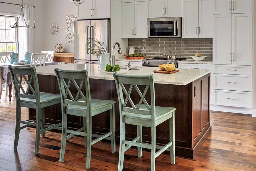 Modern kitchen design with green bar stool tables | Country Cabinets
